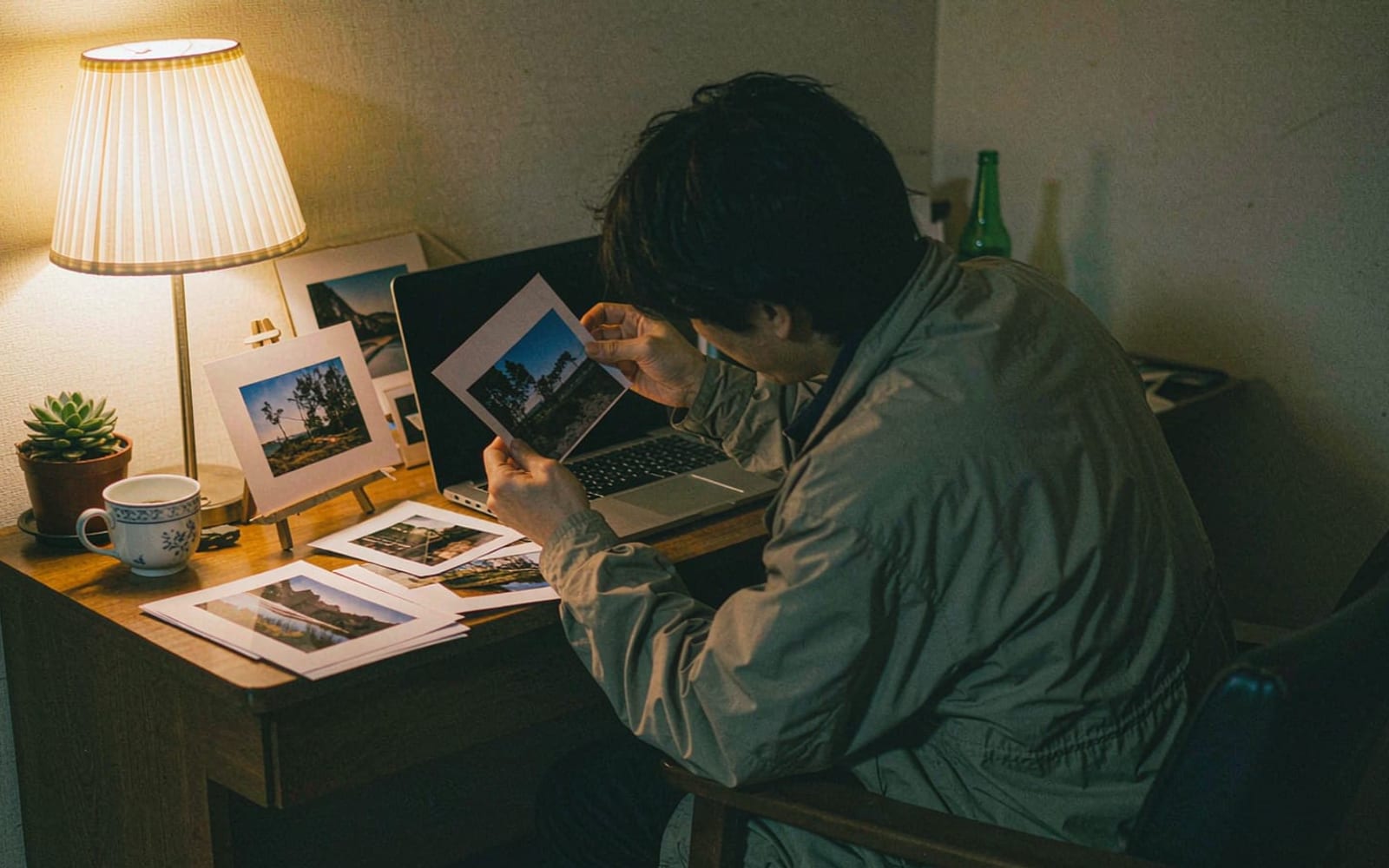 Pessoa revisando fotos impressas de viagem à mesa